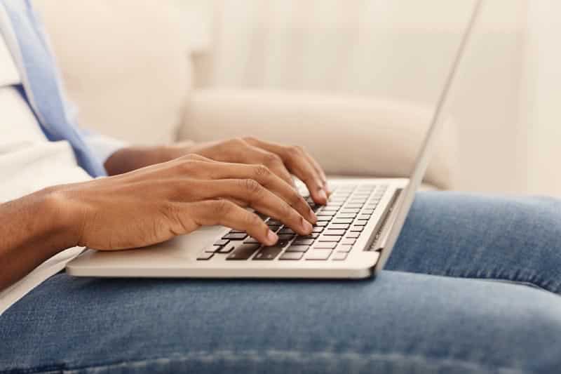 man's hands playing video game on laptop computer, keeping hands on keyboard